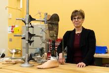 image of a woman standing in an orthotist and prosthetist lab.